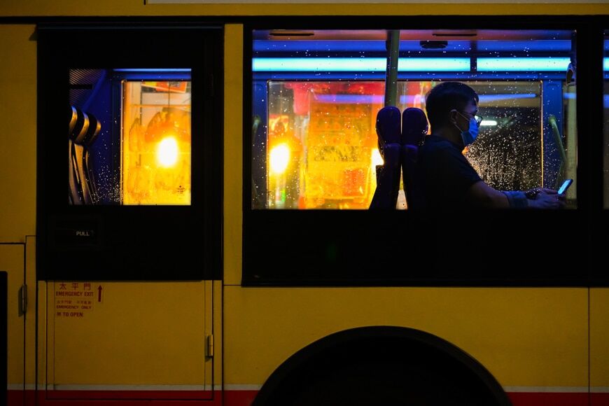 Stadsfotografie - man in een bus die 's nachts een masker draagt