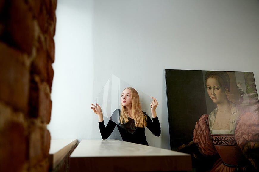 Vrouw met klassieke kunstwerk die doorzichtig plastic vel vasthoudt